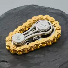 Sprocket Flywheel Chain Spinner. A mechanical chain spinner that feels incredible to fidget with. A pocket-sized machine for endlessly satisfying spins.
