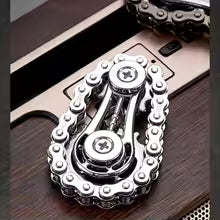 Sprocket Flywheel Chain Spinner. A mechanical chain spinner that feels incredible to fidget with. A pocket-sized machine for endlessly satisfying spins.